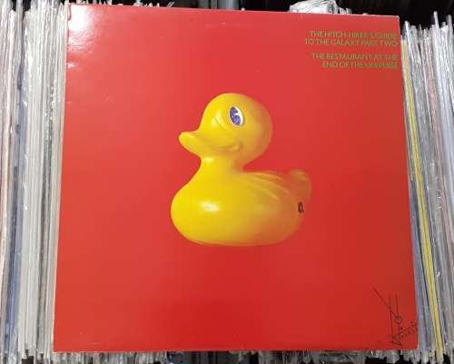 Douglas Adams ‎– The Hitch-Hiker's Guide To The Galaxy Part Two: The Restaurant At The End Of The Universe Label: Original Records – ORA 54