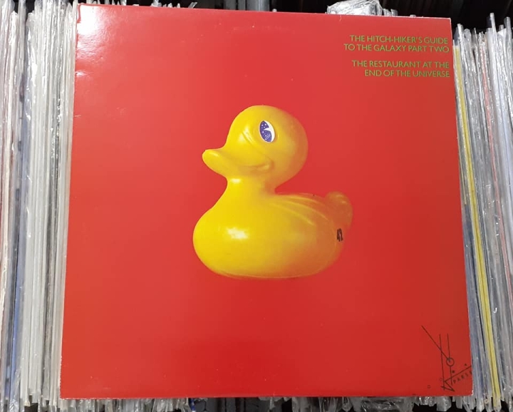 Douglas Adams ‎– The Hitch-Hiker's Guide To The Galaxy Part Two: The Restaurant At The End Of The Universe Label: Original Records – ORA 54